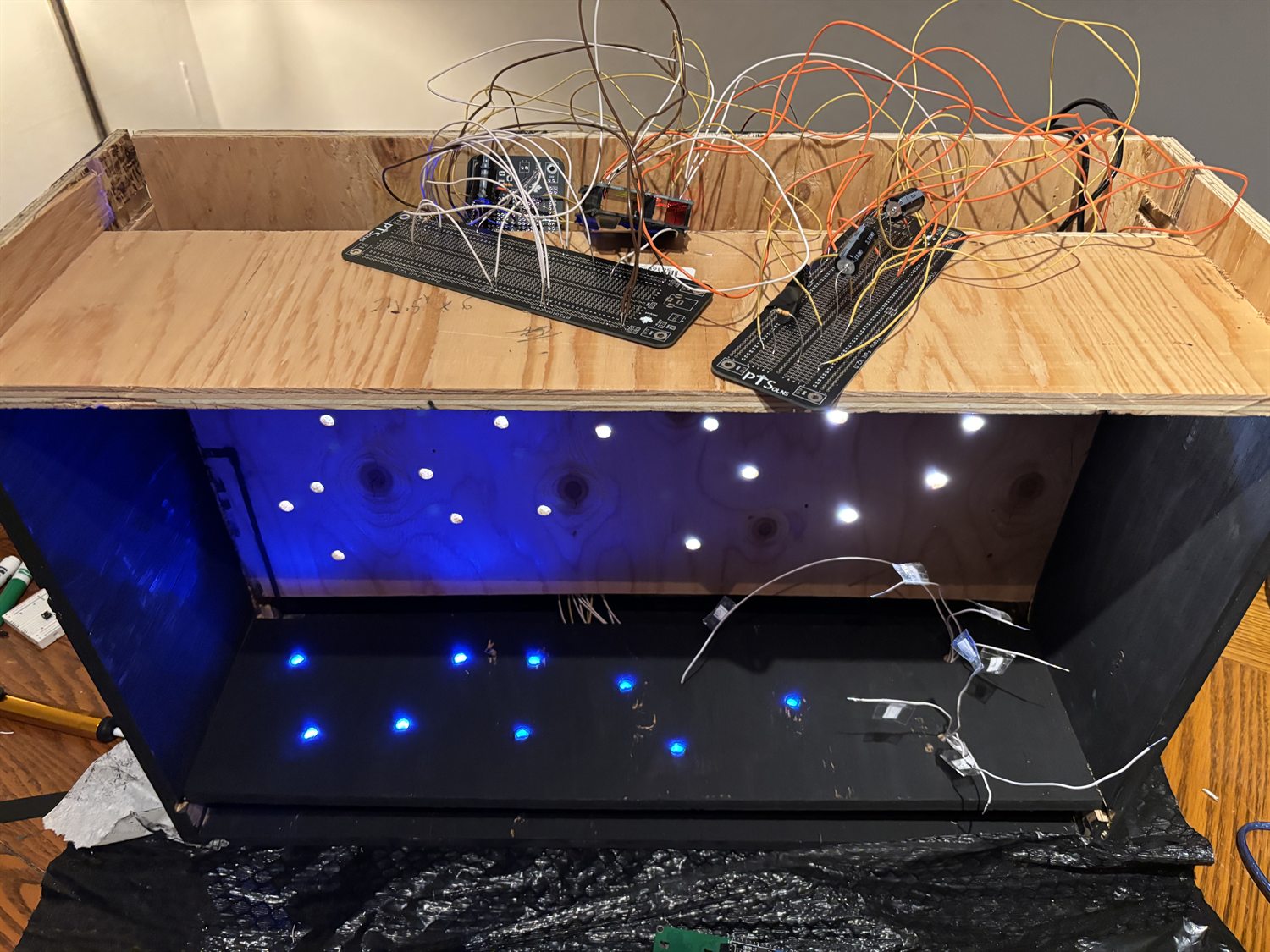 The wiring loom and protoboards above the lit star field