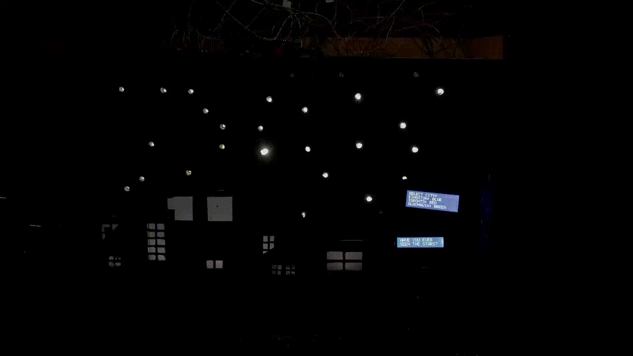 The installation cycling between cities, stars fading as the houses brighten
